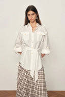 White belted linen-blend blouse with roll tab sleeves and front pockets, front view on model