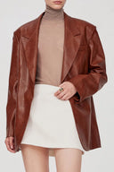 Earth tone eco wax leather blazer with notch lapels, relaxed fit, and long sleeves, front view on model.