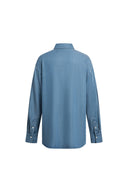Back view of a sky blue Lyocell denim shirt with long sleeves and buttoned cuffs from Fabrique Denim collection.