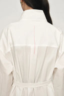 Back view of white belted shirt jacket with relaxed stand collar and subtle red stitch detail