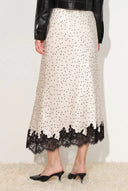 Ivory satin skirt with black polka dots and black lace trim hem, shown from back view, Skirts collection