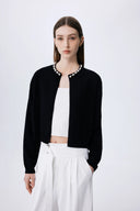 Black lyocell-wool blend knit cardigan with pearl embellishments along neckline, front view on model