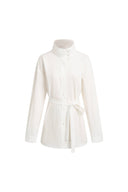 White belted shirt jacket with a stand collar and button front, front view on white background