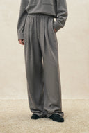 Gray pleated drawstring wide leg trousers in soft knit fabric