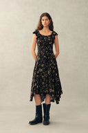 Black viscose floral dress with ruffle neckline and asymmetric hem, front view on model.
