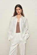 White cotton shirt with openwork trim detail on cuffs, relaxed fit, front view on model