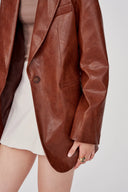 Earth tone eco wax leather blazer featuring single-button closure and notch lapel, front view on model.