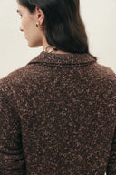 Brown and pink marled knit cardigan with a folded collar, shown from the back