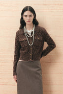 Brown cropped cardigan with gold tone buttons and chest pockets styled with a midi skirt