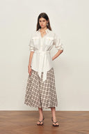 White belted linen-blend blouse with roll tab sleeves and front pockets, shown front view on model.