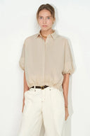 Khaki bubble puff sleeve shirt with dropped shoulders, curved hem, and collared neckline, front on-model view