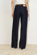 Womens dark indigo jeans with a tan contrast faux suede waistband, relaxed straight legs and raw hems