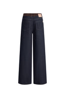Womens designer jeans in dark indigo denim with a contrasting tan faux suede waistband and relaxed straight legs