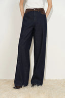 Women's dark indigo jeans with a contrasting tan faux suede waistband and relaxed straight legs
