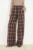 Brown plaid wide-leg pants with a layered waistband and relaxed tailored fit