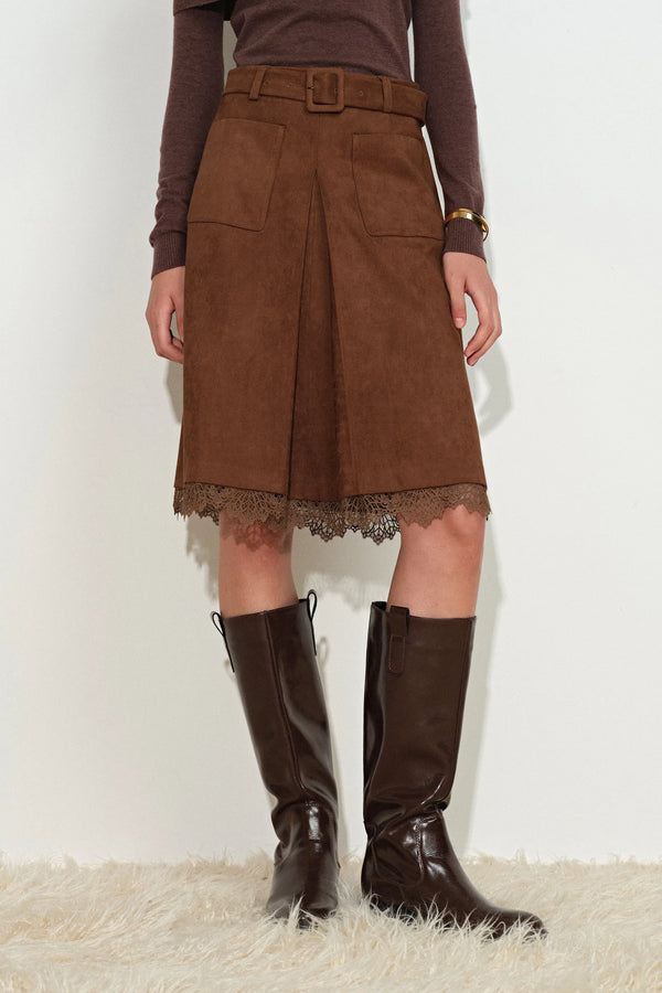 Earth tone faux-suede midi skirt with pleated front, belted waist, and lace-trimmed hem on model