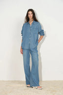 On-model view of sky blue Lyocell denim shirt with relaxed fit, button front, and chest pocket detail