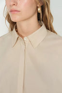 Close-up front view of a khaki cotton-blend shirt with a clean neckline and concealed button placket