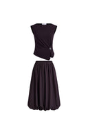 Brownish red cotton-blend twisted drape sleeveless top with decorative clasp and matching bubble skirt, front view