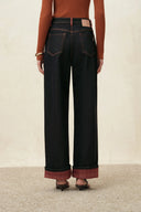 Women's straight leg jeans with contrast topstitching and folded plaid cuffs in dark denim