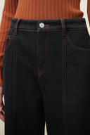 Black straight leg jeans with contrast orange topstitching and front pockets