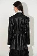 Black belted vegan leather blazer shown from the back with oversized shoulders and white ruffled cuffs