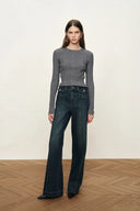 Fitted gray merino wool knit top with irregular ribbing and long sleeves styled with wide leg jeans