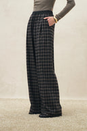 Dark plaid flannel wide leg pants with a relaxed drawstring waist
