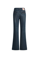 Green washed flared jeans with buckled flap pockets and slit hems