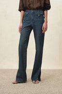 Womens green washed flare jeans with buckled flap pockets and slit hems