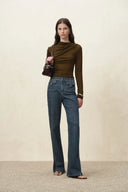 Women's flare jeans in washed cotton denim with slit hems and buckled flap pockets