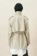 Champagne oversized belted cropped trench coat shown from the back over a white shirt