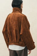 Back view of a caramel vegan suede oversized jacket with batwing sleeves and sculptural pleating