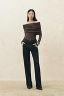 Women's brown off shoulder draped knit top with dark wide leg jeans