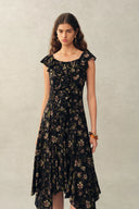 Black viscose floral dress with ruffled neckline and cascading front ruffles, front view on model