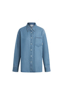 Light blue denim shirt with pointed collar, front buttons, long sleeves, and pocket detail on chest front view.