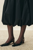 Black bubble midi skirt with gathered hem and pointed slingback heels