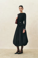 Black bubble midi skirt styled with a fitted long sleeve top and pointed heels