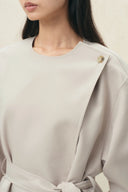 Cropped wool gabardine trench coat with tie waist and single button closure