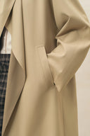 Beige wool blend designer coat with a tailored front pocket and contrast plaid lining