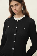 Black wool blend cardigan with silver buttons, patch pockets and a ruffled white collar