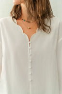 White crinkle cotton blouse with lace trimmed scalloped V neck and covered buttons