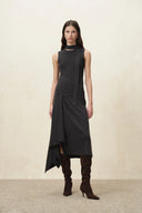 Black sleeveless knit midi dress with scarf tie, layered asymmetric skirt and tall boots