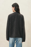 Back view of a deep grey openwork wool alpaca blend cardigan with a relaxed fit