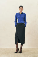 Sapphire blue wool blend knit top with a half placket and button cuffs, styled with a black midi skirt