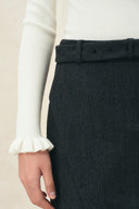 Moonlight white wool blend turtleneck top with ruffle cuff and dark tailored trousers