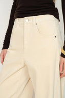 Cream corduroy barrel leg pants with a high waist and curved front pockets