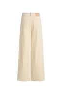 Cream wide leg corduroy pants with curved paneling and front patch pockets