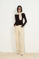 Cream barrel leg corduroy pants with a curved wide leg silhouette
