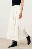 White wide leg culottes with pleated A line silhouette and waist belt detail